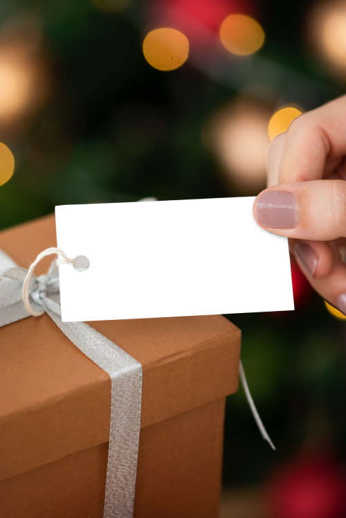 Woman holding a brown present with a card mockup transparent png - 2024790