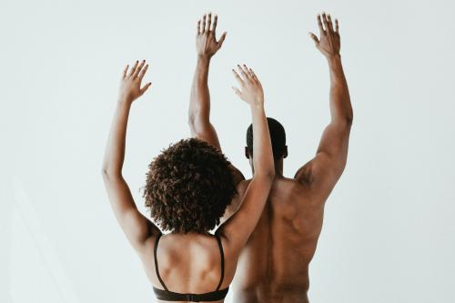 Seminude black couple raising arms in the air - 2025189