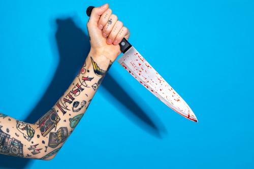 Hand with tattooed holding a knife - 2056066