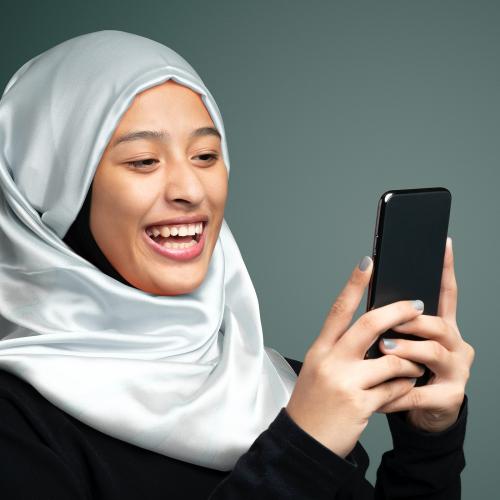 Portrait of a Muslim woman using a mobile phone - 2209915