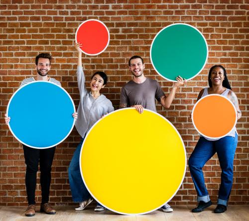 Diverse people holding colorful round boards - 537768