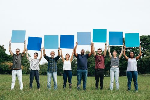 Diverse people holding blue squared boards in the park - 537896