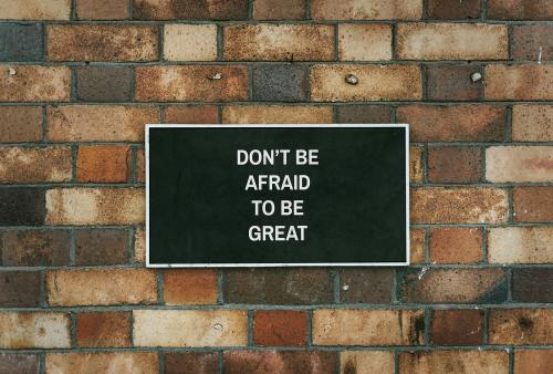 Don't be afraid to be great board mockup on a brick wall - 539121