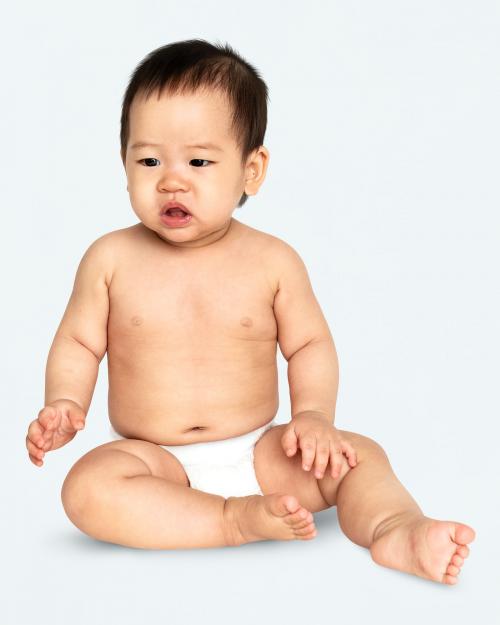 Baby in a diaper sitting on the floor - 546235
