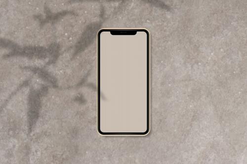 Phone mockup on brown marble background vector - 1217745