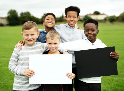 Group of young boys showing blank papers - 525867