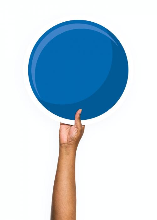 Hand holding a round blue cardboard prop - 526477