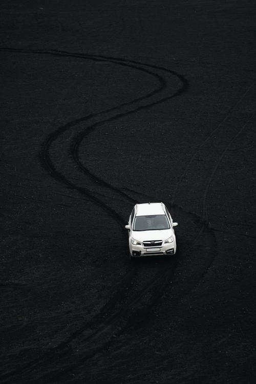 Car driving on black sand beach in Iceland - 2042647