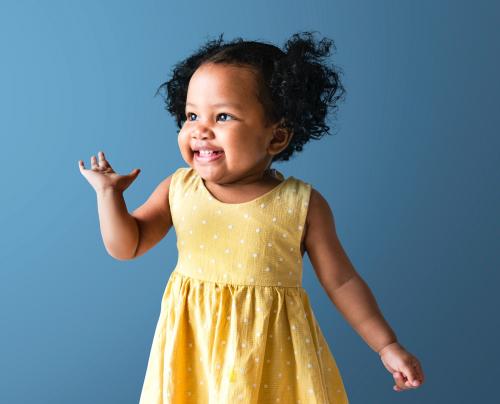 Happy little girl in a yellow dress - 536037