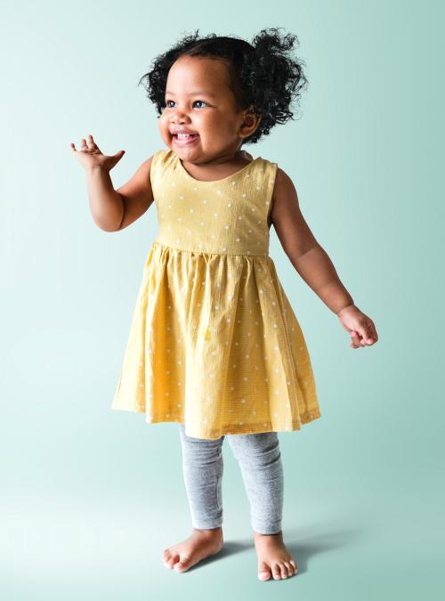 Happy little girl in a yellow dress - 536051
