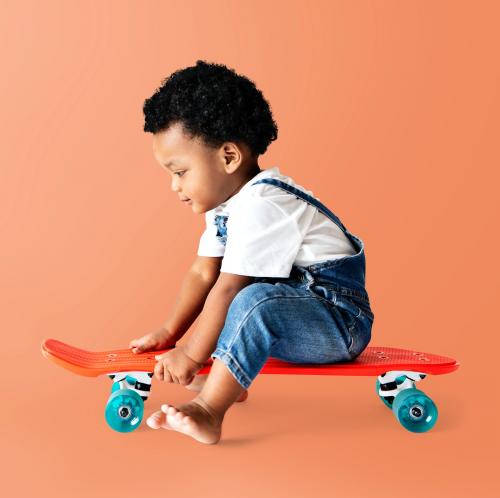Cute little boy sitting on a skateboard - 536082
