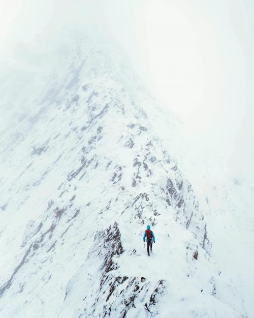 Mountaineer using an ice axe to climb Forcan Ridge in Glen Shiel, Scotland - 2221561
