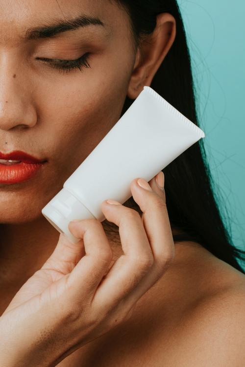 Woman holding a facial cream container - 2224914