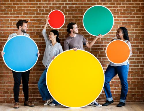 Diverse people holding colorful round boards - 537807