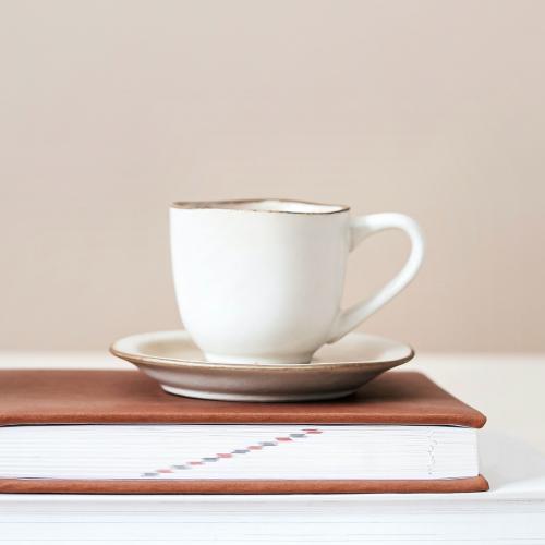 White tea cup on a book - 2259541