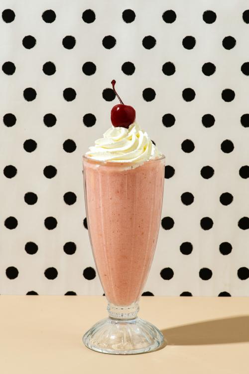 Strawberry milkshake with a maraschino cherry on top - 2280571