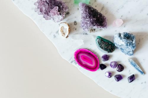 Colorful healing crystals on a marble countertop - 2281989