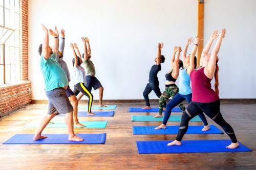 Trainer and her students in a Urdhva Hastasana pose - 2046907