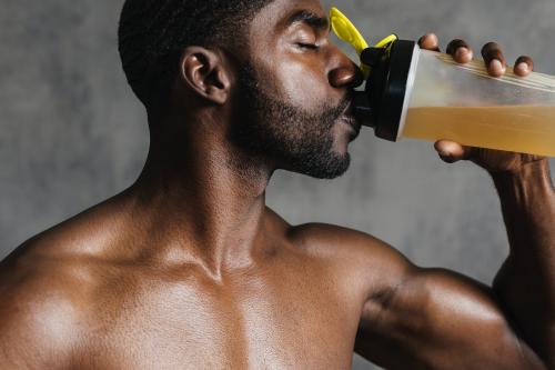 Black man drinking energy drink - 2107387