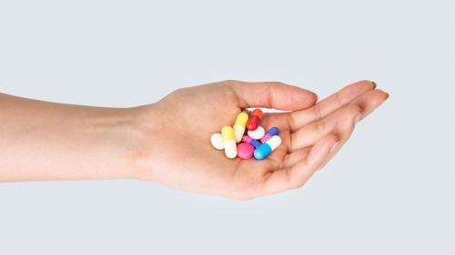Hand taking pills treatment isolated - 2051100