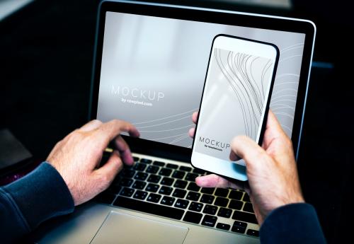 Businessman using a laptop and a mobile phone mockup - 502937