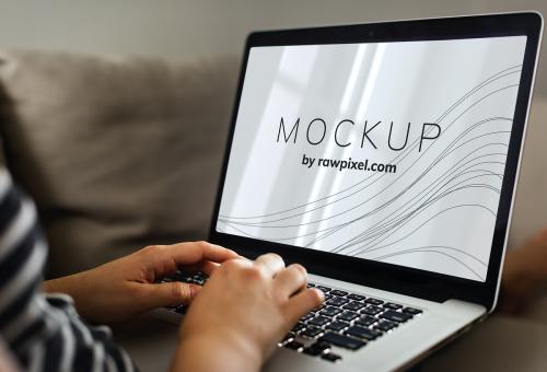 Woman using a laptop with a screen mockup - 502967