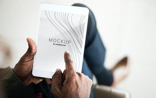 Man playing on a tablet with a screen mockup - 503021