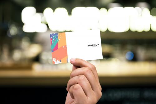 Holding up a business card mockup - 502677