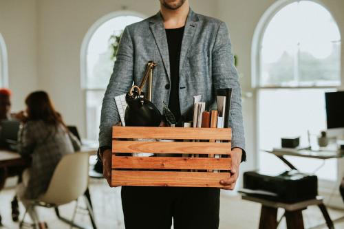 Man carrying a wooden box in the office - 2204732