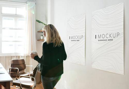 Woman in a working space with poster design mockups - 502783