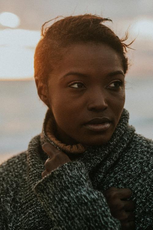 Black woman at the beach during sunset - 2025066