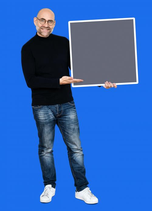 Cheerful man presenting a blank gray square board - 493284