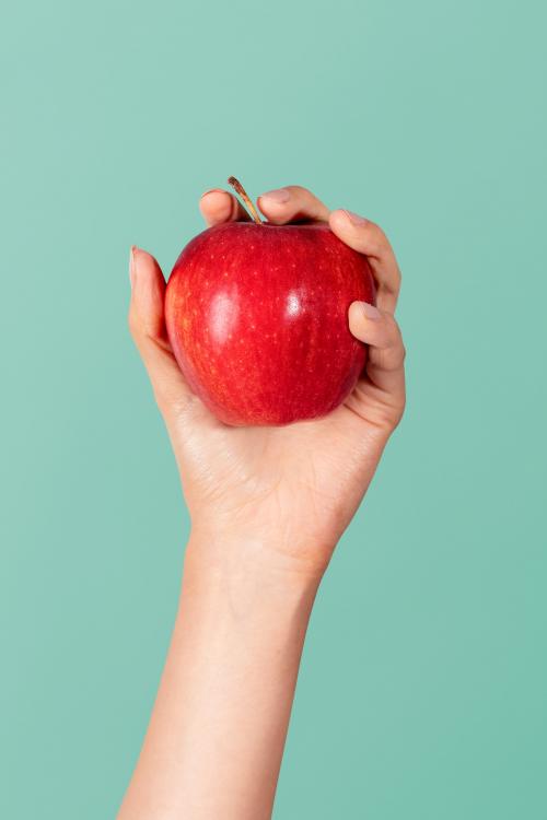 Hand showing a fresh red blush apple - 2052103