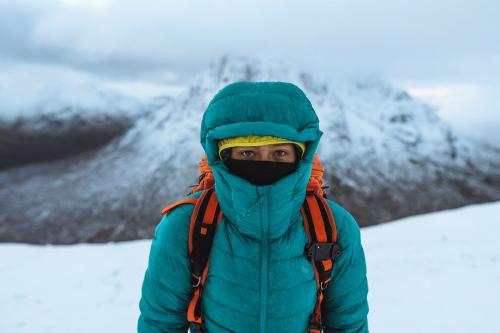Female mountaineer climbing in wintertime at Glen Coe, Scotland - 2221498