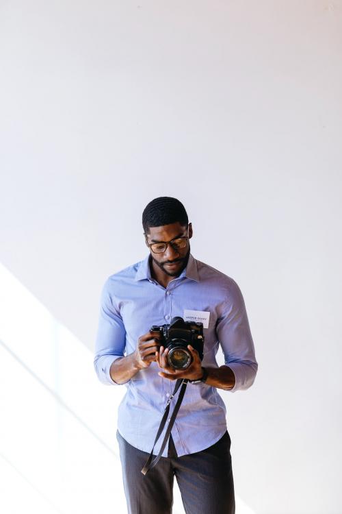 Black photographer using a retro film camera - 2025324