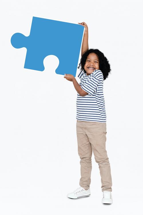 Happy boy holding a puzzle piece - 491776
