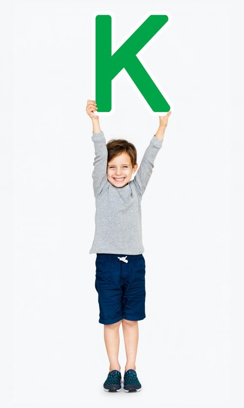 Happy boy holding the letter K - 491813