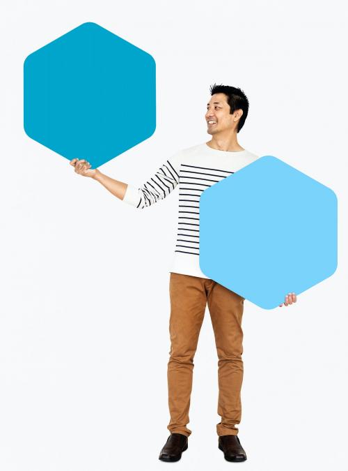Cheerful man showing blue hexagon boards - 490993