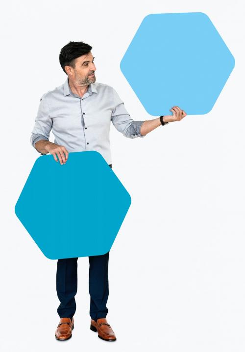 Cheerful man showing blue hexagon shaped boards - 491005