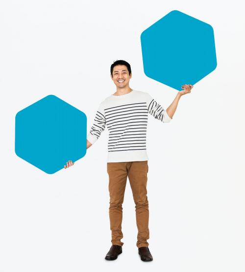 Cheerful man showing blue hexagon shaped boards - 491026