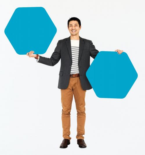 Cheerful man showing blue hexagon shaped boards - 491032