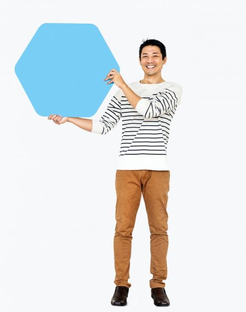 Cheerful man showing a blank blue hexagon board - 491058