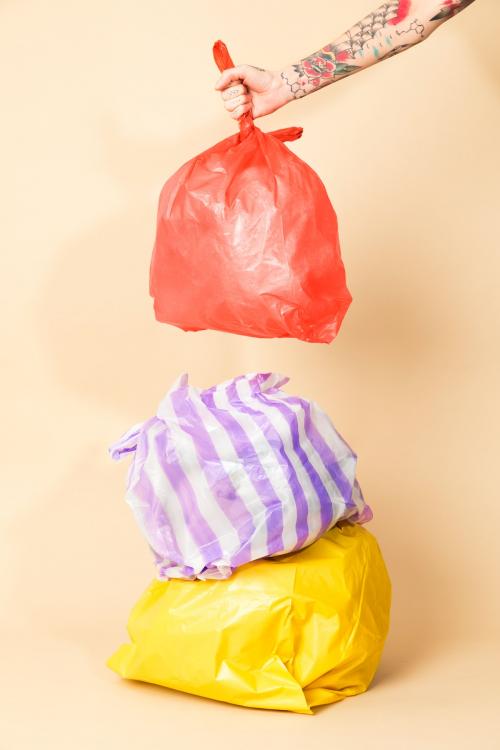 Colorful garbage bags isolated on yellow background - 2052989
