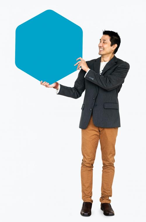 Cheerful man showing a blank blue hexagon shaped board - 491124