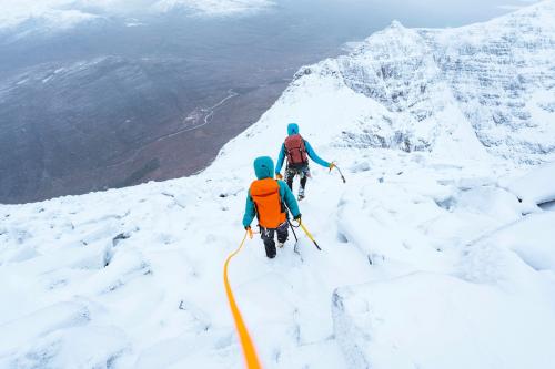 Mountaineers climbing a snowy Liathach Ridge in Scotland - 2221568