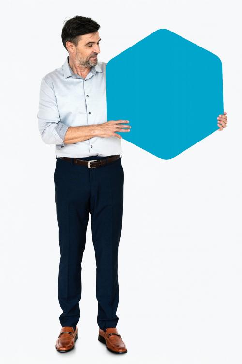 Cheerful man showing a blank blue hexagon shaped board - 491137