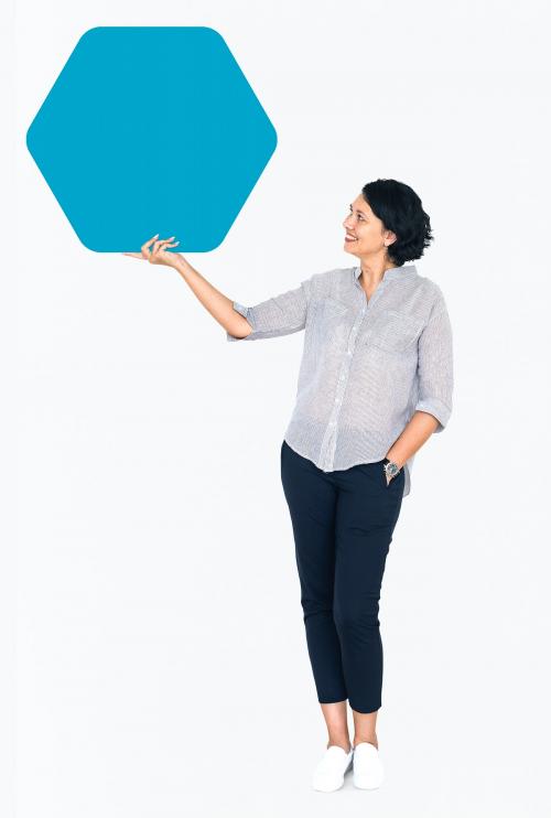 Cheerful woman showing a blank blue hexagon shaped board - 491180
