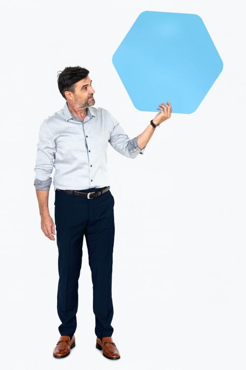 Cheerful man showing a blank blue hexagon shaped board - 491202