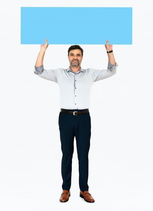 Cheerful man showing a blank blue banner - 491228