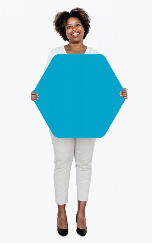 Cheerful woman showing a blank blue hexagon shaped board - 491233
